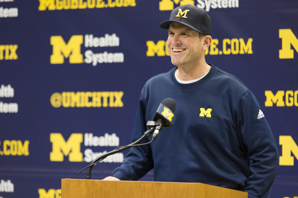 Michigan football coach Jim Harbaugh answers questions following the first day of spring practice at a press conference at Schembechler Hall Tuesday. (ALLISON FARRAND / Daily)