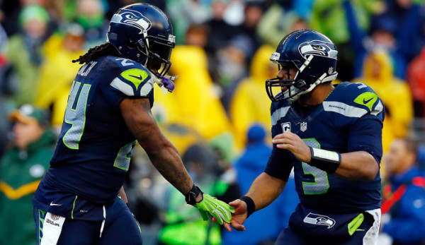 SEATTLE, WA - JANUARY 18: Marshawn Lynch #24 celebrates with Russell Wilson #3 of the Seattle Seahawks during the fourth quarter of the 2015 NFC Championship at CenturyLink Field on January 18, 2015 in Seattle, Washington. (Photo by Tom Pennington/Getty Images)