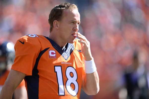 Oct 5, 2014; Denver, CO, USA; Denver Broncos quarterback Peyton Manning (18) licks his fingers in the first quarter against the Arizona Cardinals at Sports Authority Field at Mile High. Mandatory Credit: Ron Chenoy-USA TODAY Sports ORG XMIT: USATSI-180154 ORIG FILE ID: 20141005_krj_ac4_0072.JPG