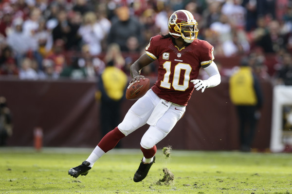 Washington Redskins quarterback Robert Griffin III looks for an opening to throw during the first half of an NFL football game against the Philadelphia Eagles in Landover, Md., Sunday, Nov. 18, 2012. (AP Photo/Alex Brandon)
