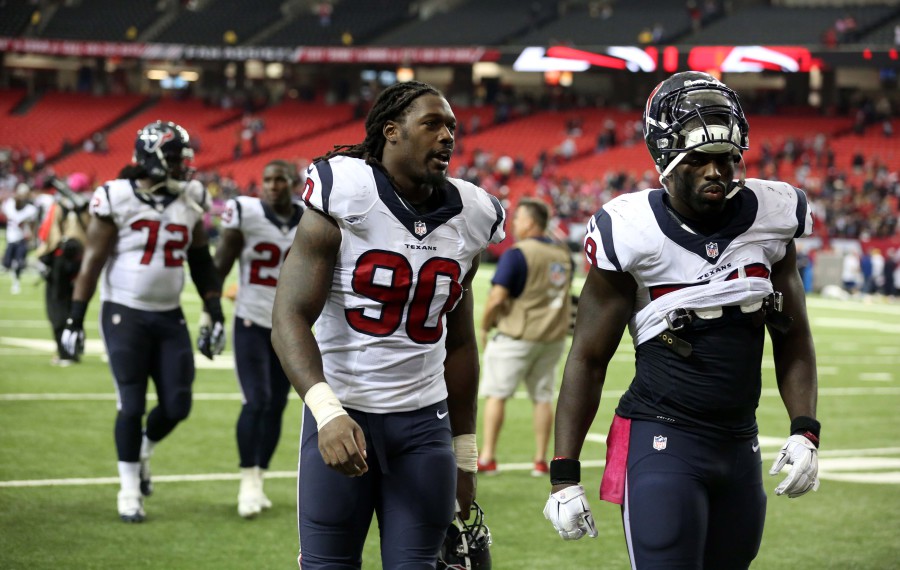 Oct 4, 2015; Atlanta, GA, USA; Houston Texans linebacker Jadeveon Clowney (90) and linebacker Whitney Mercilus (59) walk off of the field after their loss to the Atlanta Falcons at the Georgia Dome. The Falcons won 48-21. Mandatory Credit: Jason Getz-USA TODAY Sports