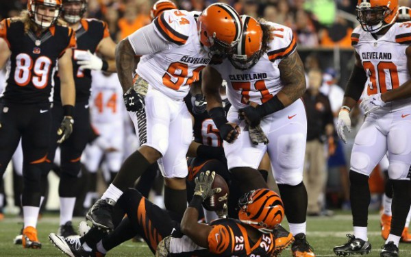 Nov 5, 2015; Cincinnati, OH, USA; Cleveland Browns defensive end Randy Starks (94) and nose tackle Danny Shelton (71) stand over Cincinnati Bengals running back Giovani Bernard (25) in the first half at Paul Brown Stadium. Mandatory Credit: Aaron Doster-USA TODAY Sports