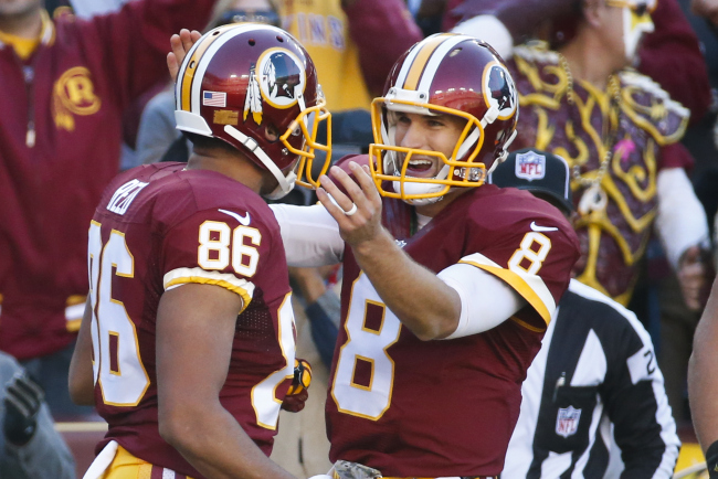 Washington Redskins quarterback Kirk Cousins (8) congratulates teammate tight end Jordan Reed (86) after his touchdown during the first half of an NFL football game against the New Orleans Saints in Landover, Md., Sunday, Nov. 15, 2015. (AP Photo/Alex Brandon)