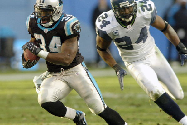 Carolina Panthers' DeAngelo Williams (34) runs past Seattle Seahawks' Deon Grant (24) for a touchdown in the fourth quarter of the Panthers' 13-10 win in an NFL football game in Charlotte, N.C., Sunday, Dec. 16, 2007. (AP Photo/Mike McCarn)