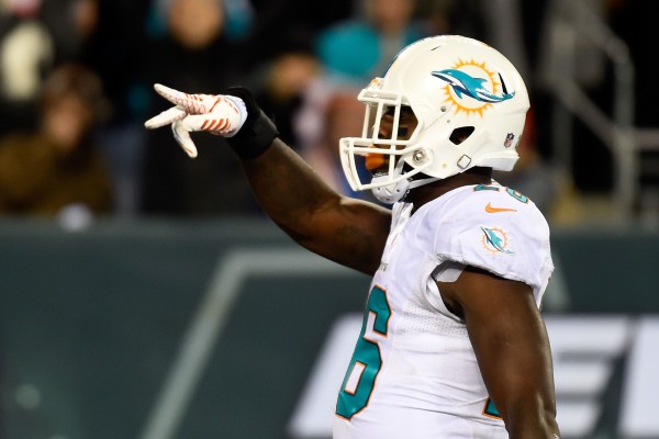 EAST RUTHERFORD, NJ - DECEMBER 01: Lamar Miller #26 of the Miami Dolphins celebrates scoring a 4 yard touchdown in the fourth quarter to tie the game against the New York Jets at MetLife Stadium on December 1, 2014 in East Rutherford, New Jersey. (Photo by Alex Goodlett/Getty Images)