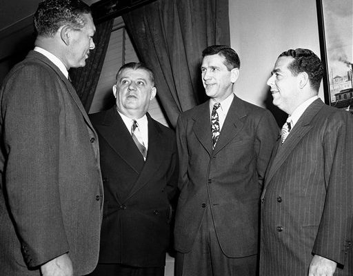 Four of the professional footballers attending the NFL meeting hold a pre-session parley in New York City, April 6, 1945. Left to right: Earl Curly Lambeau, head coach of Green Bay Packers; Bert Bell, president of the Pittsburgh Steelers; Elmer Layden, NFL president; and Fred L. Mandel, Detroit Lions owner. (AP Photo/Harry Harris)