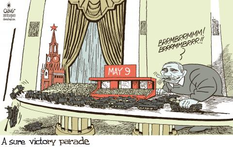 Cartoon showing Putin sitting at his large white table, playing with a miniature version of the Victory Parade in Moscow. He is moving a toy tank with his hand while making ‘brrmbrrmmm!’ Sounds. The caption reads: ‘A sure victory parade’.