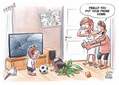 Cartoon showing a devastated living room: a large flatscreen TV has a shattered screen, lamps and plants have toppled over, the glass of a picture frame has broken. Two parents stand in the doorway looking at their child, who is standing in the middle of the living room with a football. The mom has her hands to her head in surprise and consternation, but the dad gives the child two thumbs up and says: 'Finally! You put your phone down.'