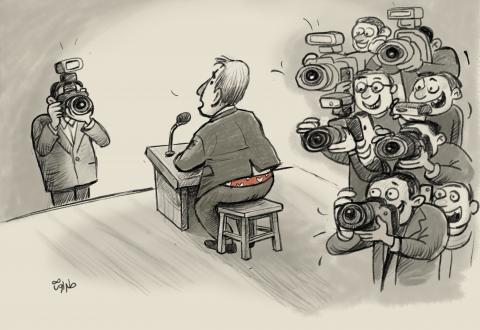 A press conference where reporters focus on a man’s exposed underwear