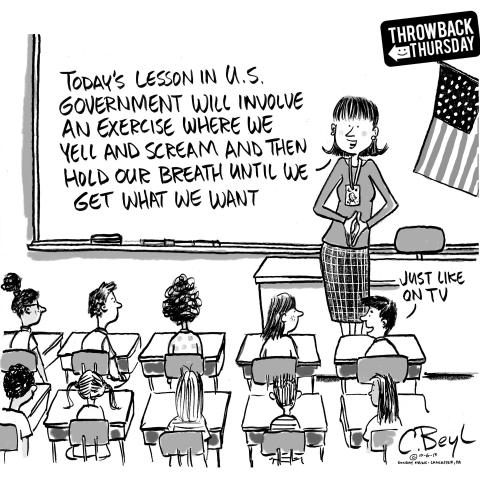 Teacher addressing classroom of kids about US government