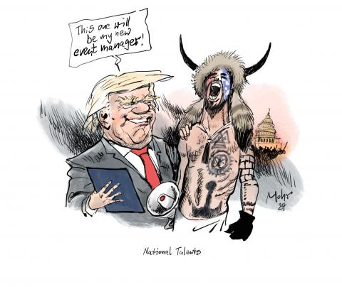 The so-called shaman during the storming of the Capitol three years ago next to President Trump