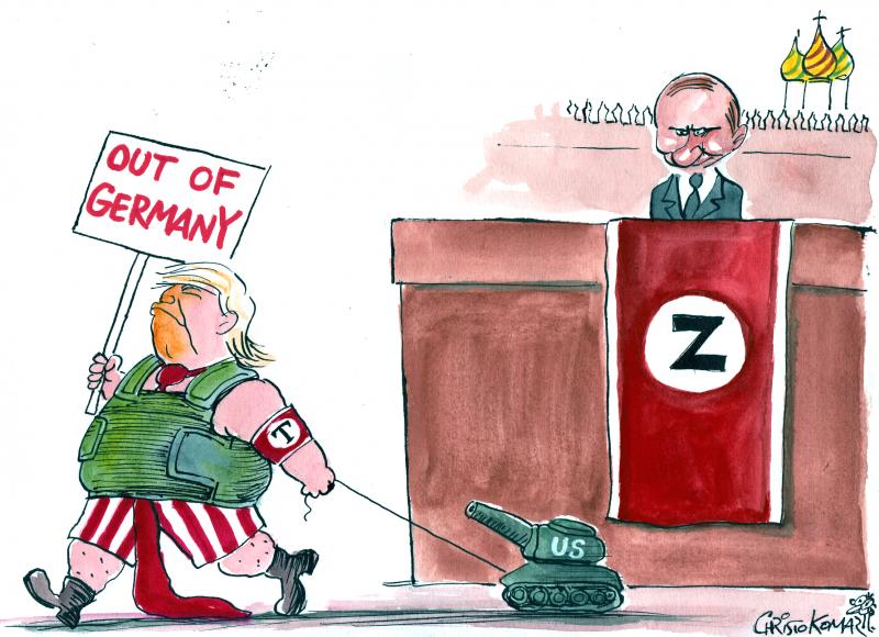 Cartoon showing Donald Trump pulling a toy tank and a sign that reads 'Out of Germany'. He is walking past Putin standing on a podium wit a banner with a 'Z on it and the Kremlin behind it, resembling the setting of Russia's yearly Victory Parade.