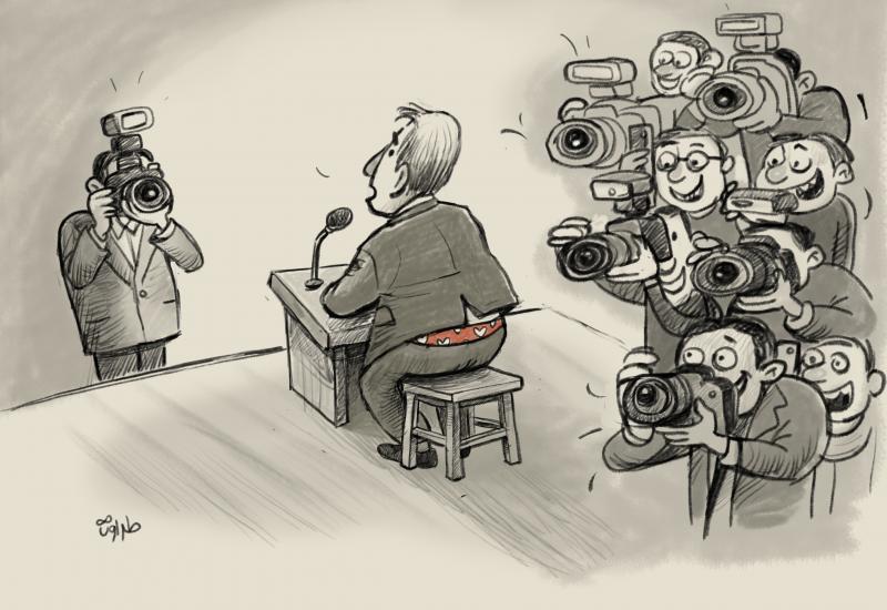 A press conference where reporters focus on a man’s exposed underwear