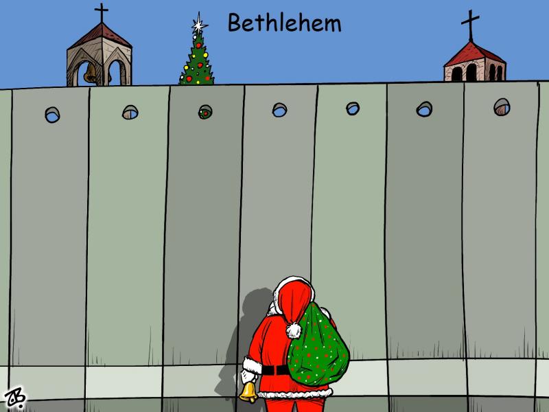 Santa in front of the separation wall in Bethlehem