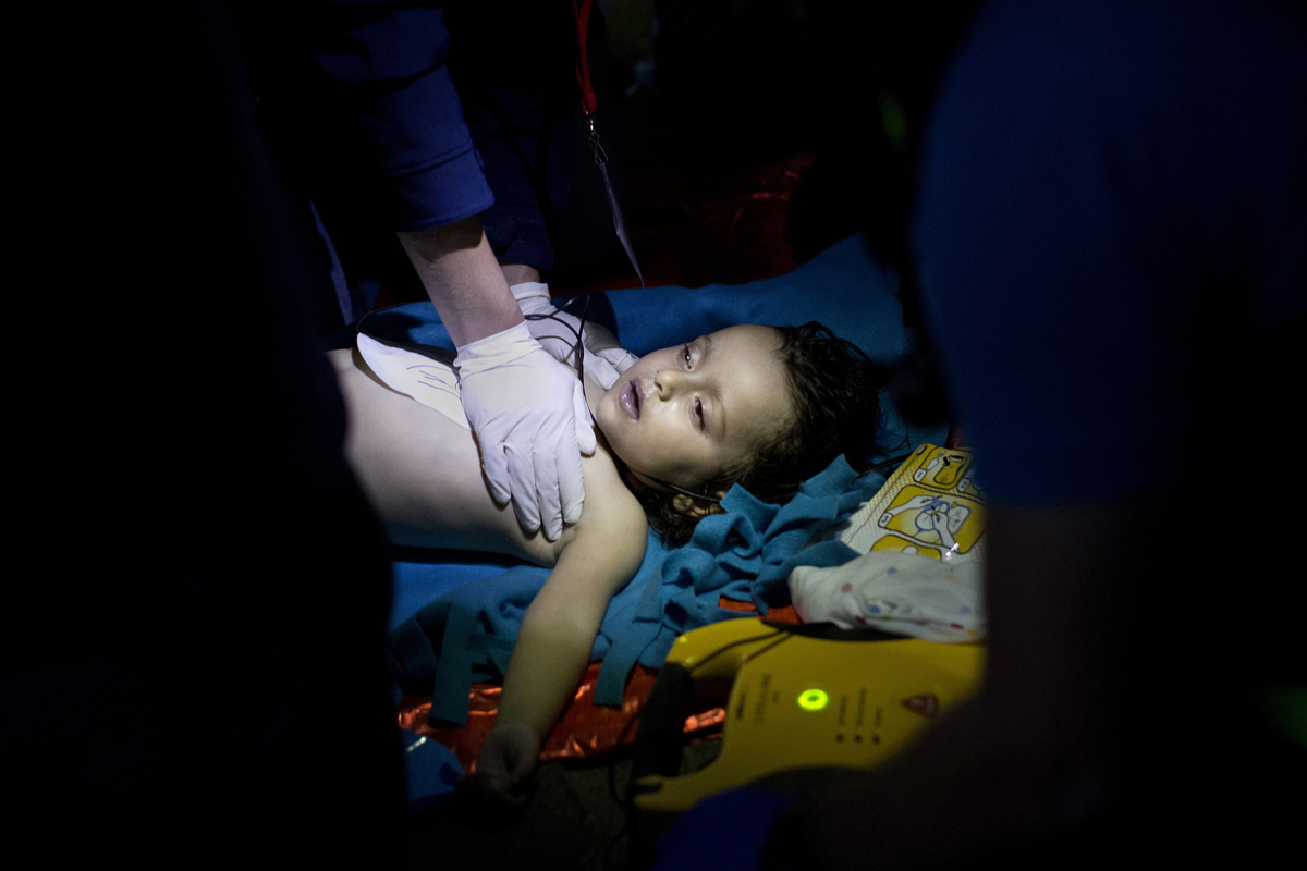 Doctors and paramedics try to revive a baby after boat with refugees and migrants sunk while attempting to reach the Greek island of Lesbos from Turkey, on October 28, 2015. At least five migrants including three children, died on October 28, 2015 after four boats sank between Turkey and Greece.