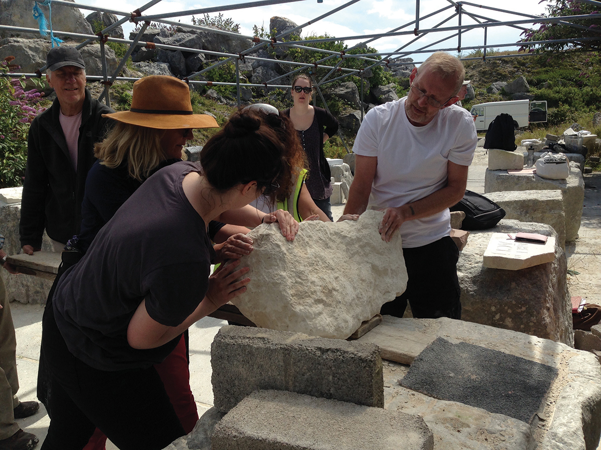 Rolling one of the stones into position on one of the ‘carving bankers’ (pieces of stone of this size can weigh around 140 pounds/ten stone)