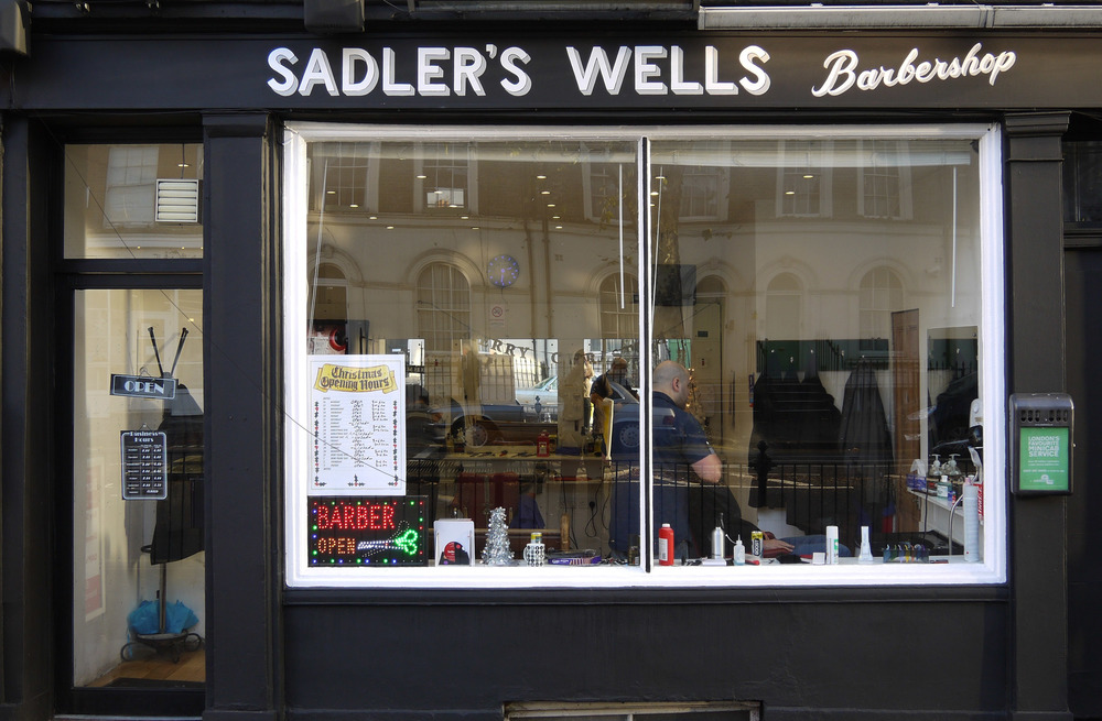Signage for a barber shop opposite Sadler's Wells in Islington