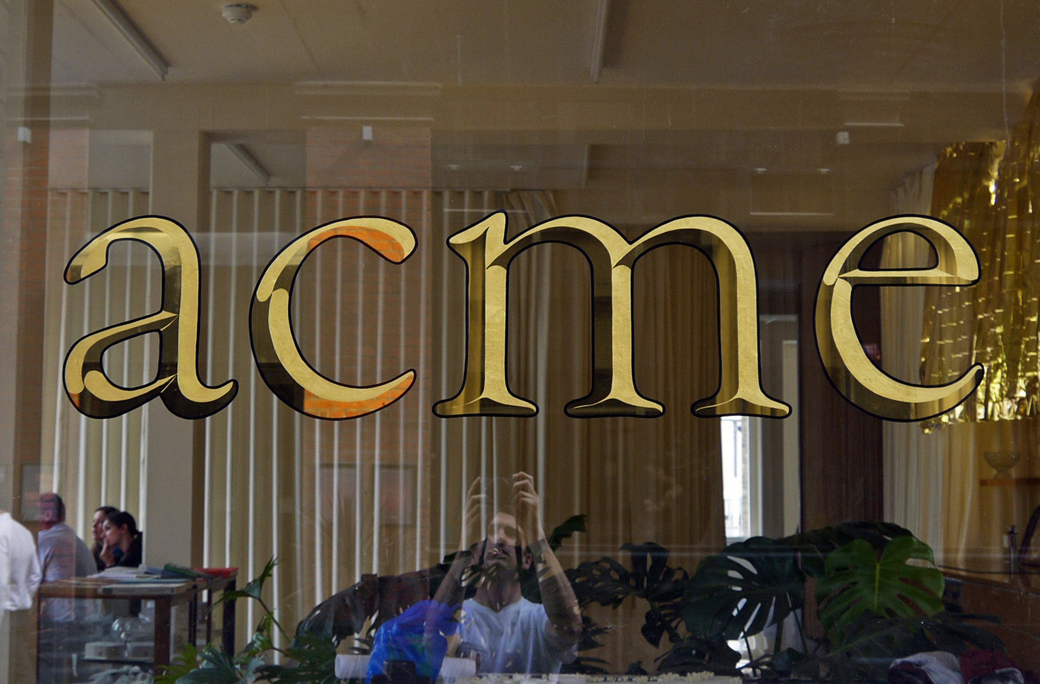 Two-tone window gilding for acme, an architecture and design studio based in Shoreditch. Made using 23-carat gold leaf in a mirrored and matte finish