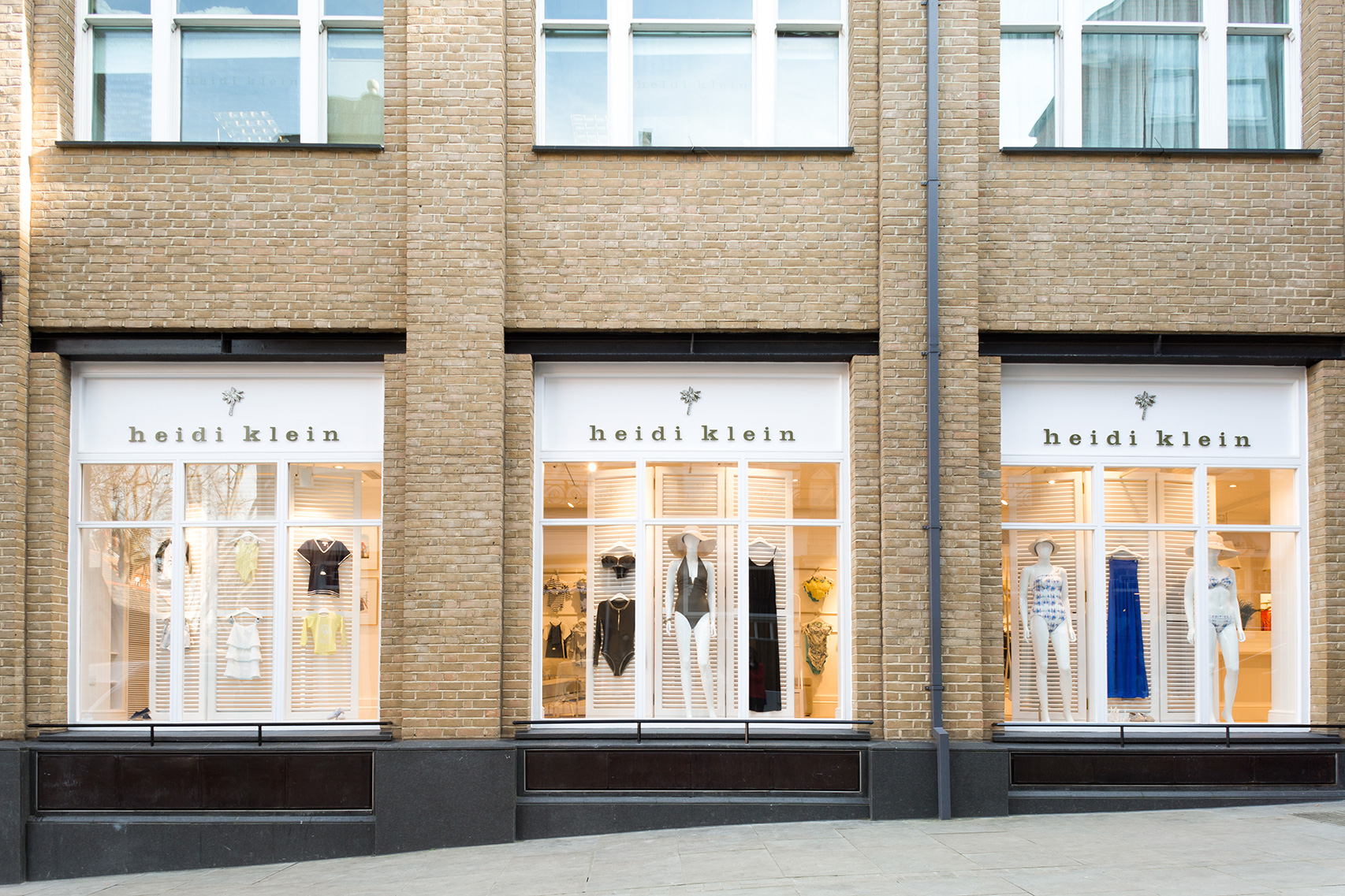 2 - Three full-height windows feature full-height screens, resembling grand-scale domestic window shutters