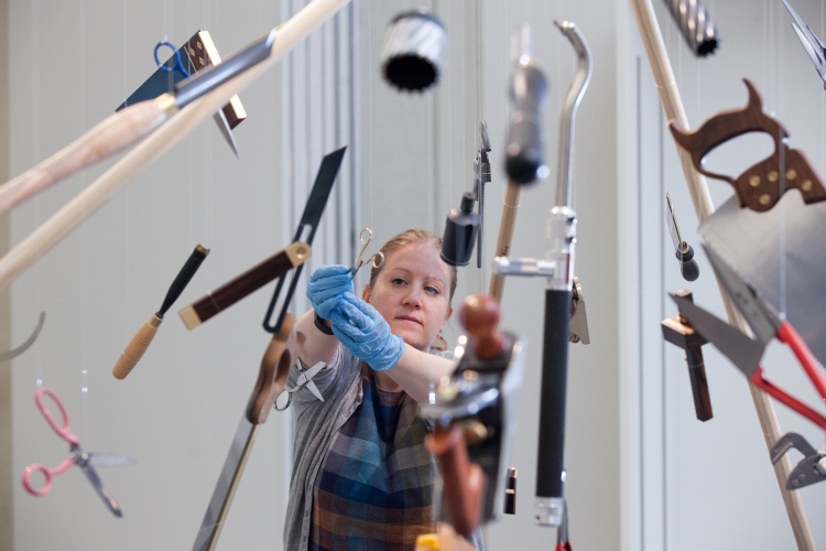 Exhibition curator Louisa Briggs with the Made in Sheffield tool explosion. Photo © Andy Brown