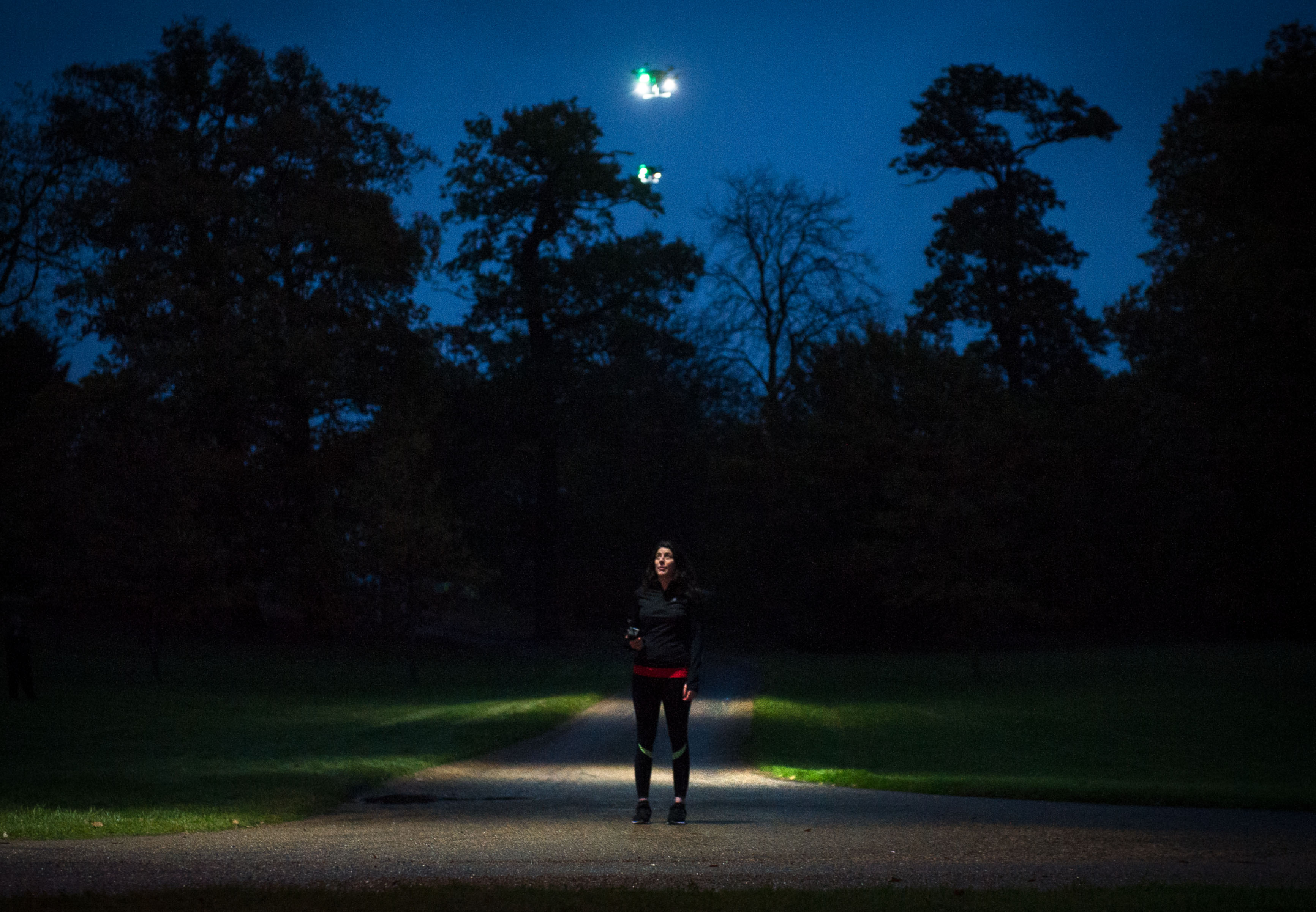 EMBARGOED TO 0001 WEDNESDAY NOVEMBER 16 EDITORIAL USE ONLY Jogger Francestca Monticelli during the launch of ÔFleetlightsÕ Ð a prototype range of smart drones fitted with high-powered lights, which have been designed by Direct Line and can be ordered by phone to improve road and pedestrian safety at night, at Borehamwood, Hertfordshire. PRESS ASSOCIATION Photo. Issue date: Wednesday November 16, 2016. The insurance provider has partnered with the drone technology specialists behind Mission Planner to create the prototype Fleetlights mobile phone app, which makes it simple to control the service and track your journey using your GPS location. The software is the first time the ÔLight my WayÕ functionality - which tracks and maintains a fixed distance ahead of a subject, rather than behind - has been used. Photo credit should read: John Nguyen/PA Wire