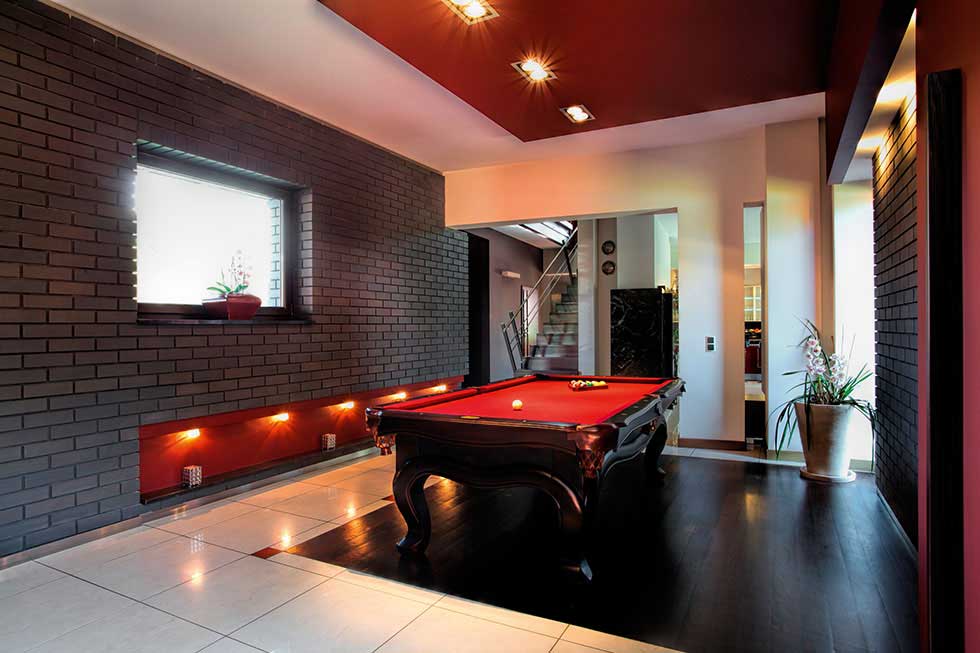 games room with red walls and snooker table