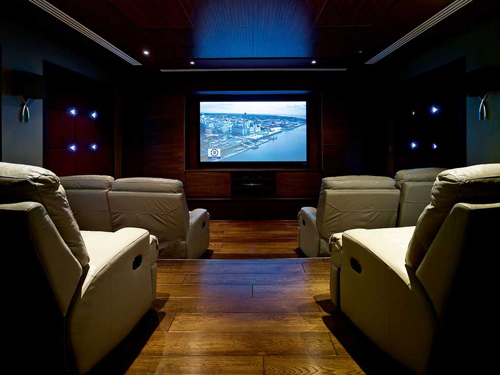media room with staggered cinema seating and cinema screen