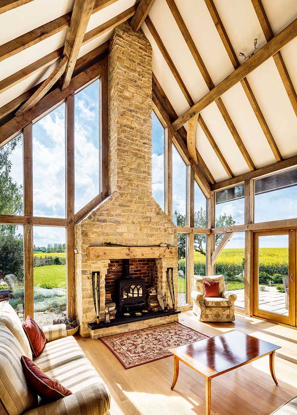 Double height drawing room with exposed chimney stack