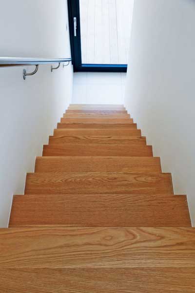 Oak stairs lead up to the bridged landing