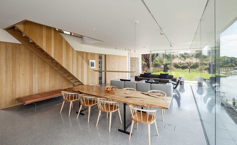 dining room with wooden table and chairs in modern open plan home