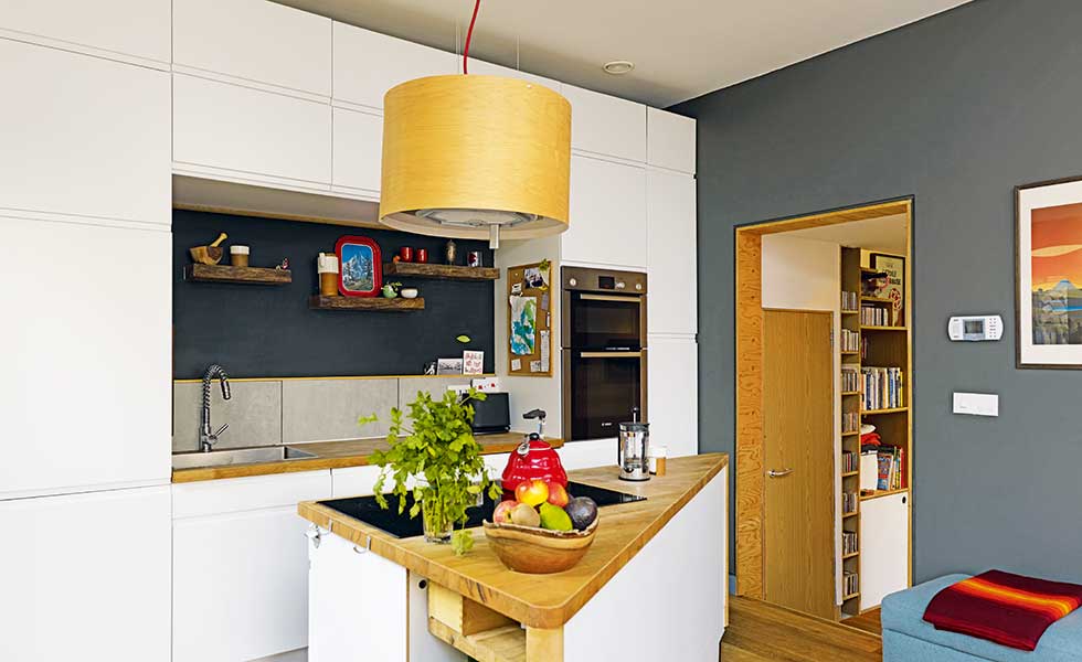 white and teal contemporary kitchen with triangular shaped island