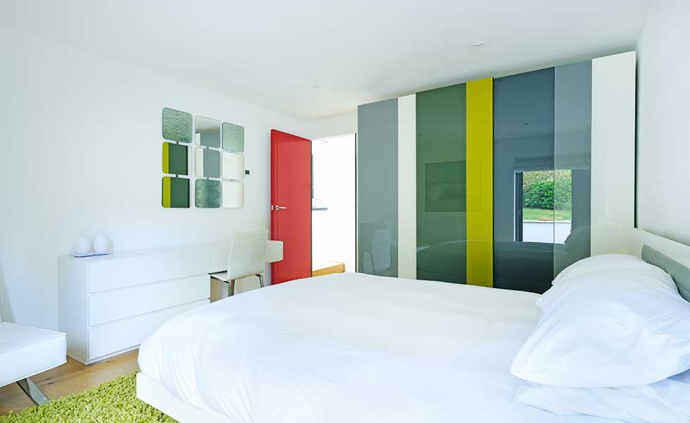 Guest bedroom with coloured glass walls