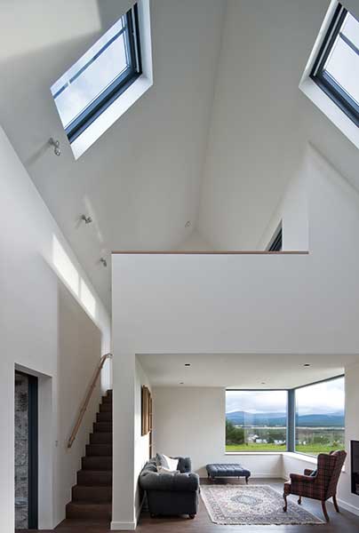 vaulted ceiling in living space with mezzanine