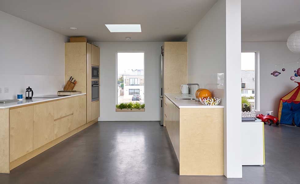 birch-ply-kitchen-with-picture-window-and-rooflight-providing-natural-light