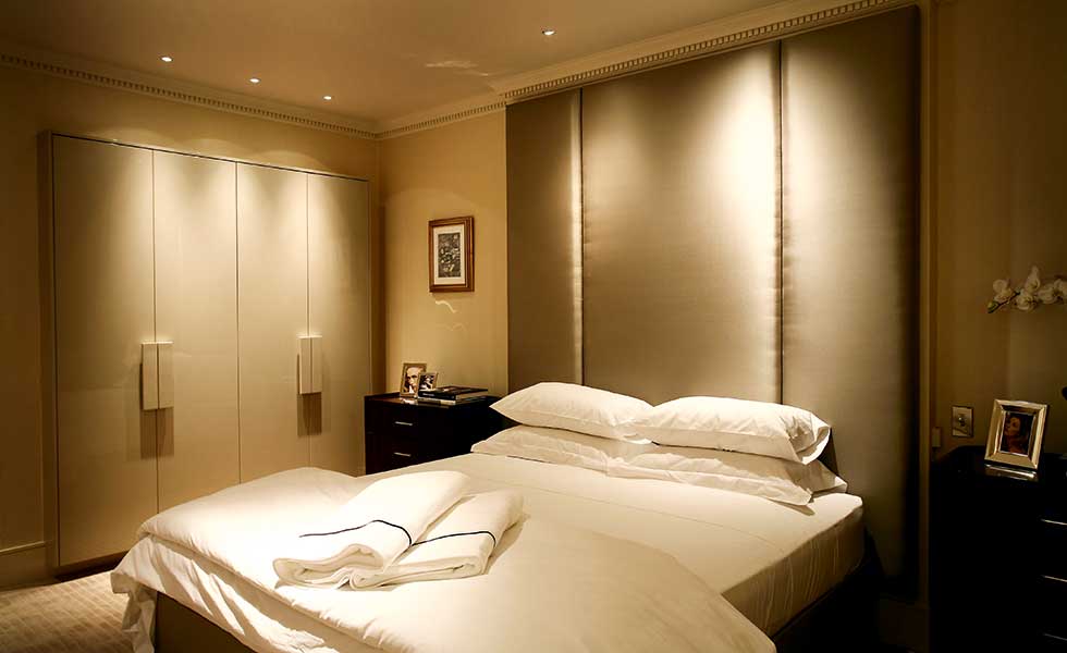 Strategically placed spotlights above the headboard, foot of the end and above wardrobes create a relaxing mood in this bedroom