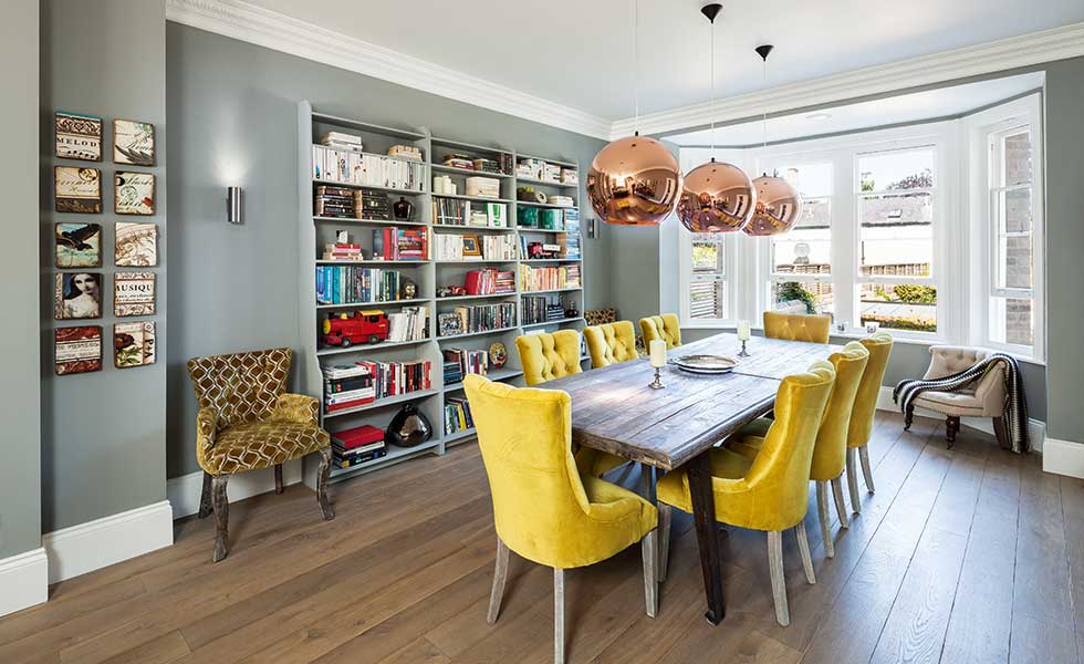Statement copper lights create a focal point above a dining table