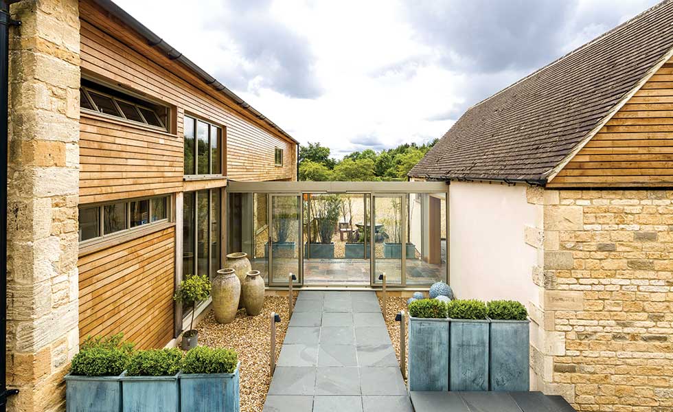 Stone and timber barn conversion with aluminium glazed link