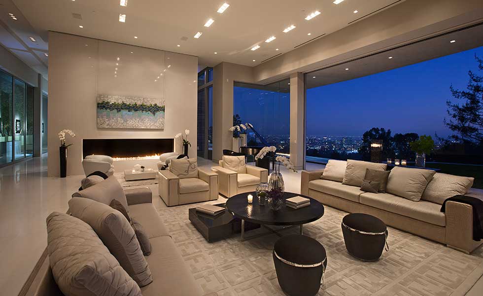 A large open plan living space overlooking the city of Los Angeles at night