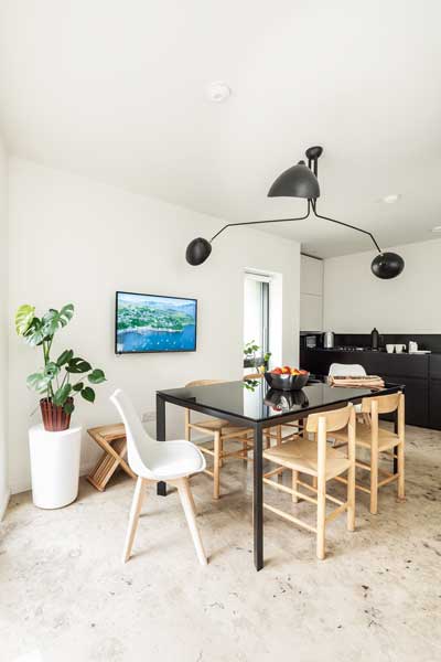 open plan kitchen diner with black dining table