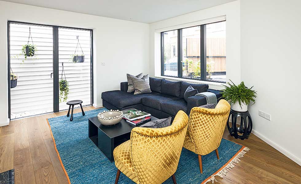 contemporary living room with yellow armchairs and black sofa