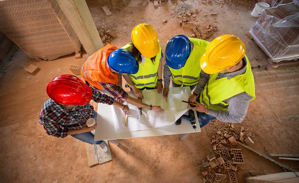 builder and clients looking at plans