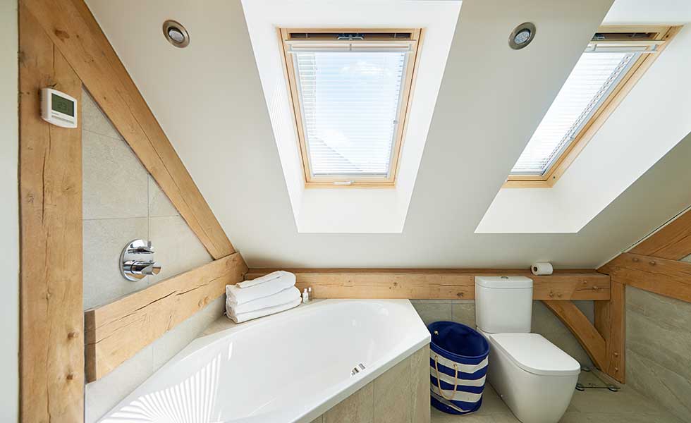 En suite with roof lights and timber beams