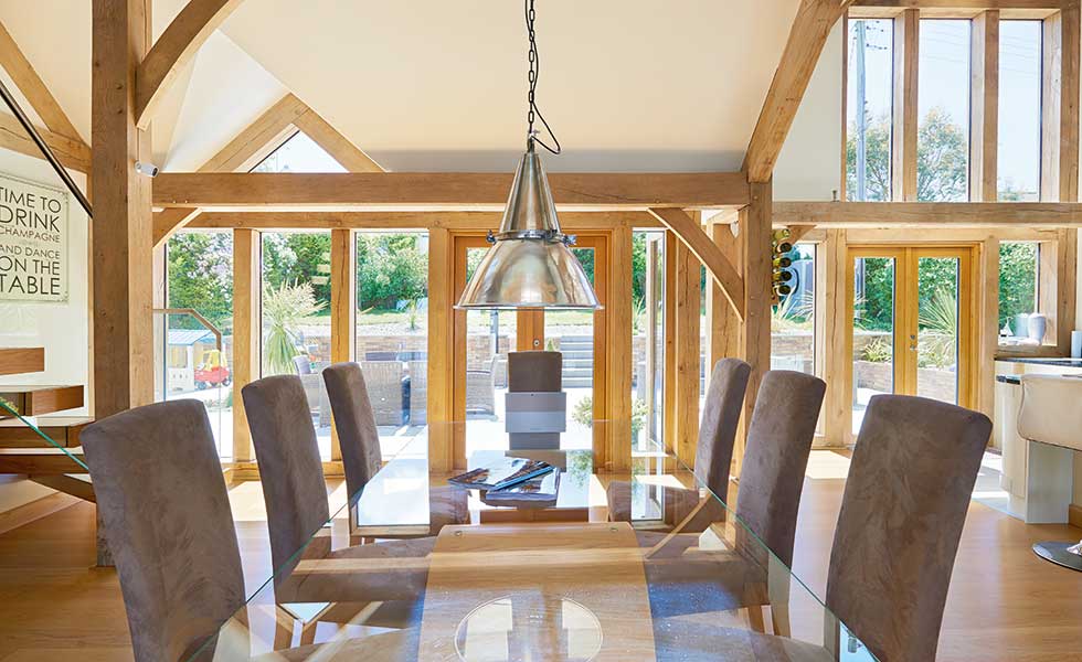 Dining room with exposed timber beams and French doors