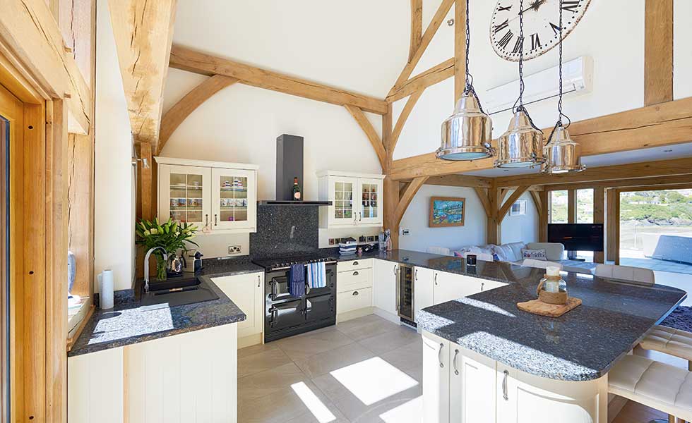 Double height kitchen with exposed oak frame
