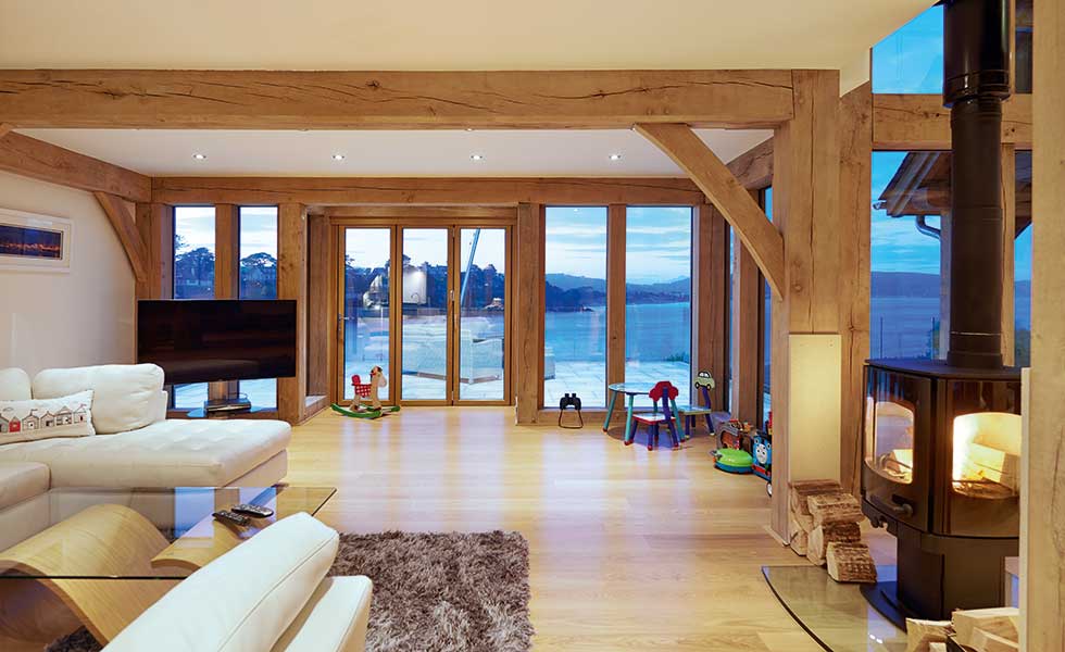 Living rooms with exposed oak beams and sea view