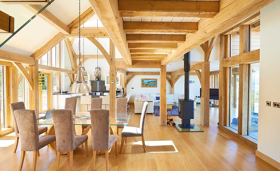 Kitchen diner with exposed oak frame and woodburner