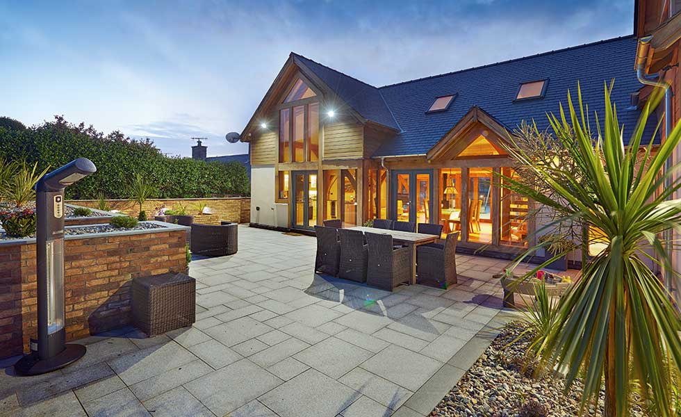 Contemporary oak frame house with timber cladding and render