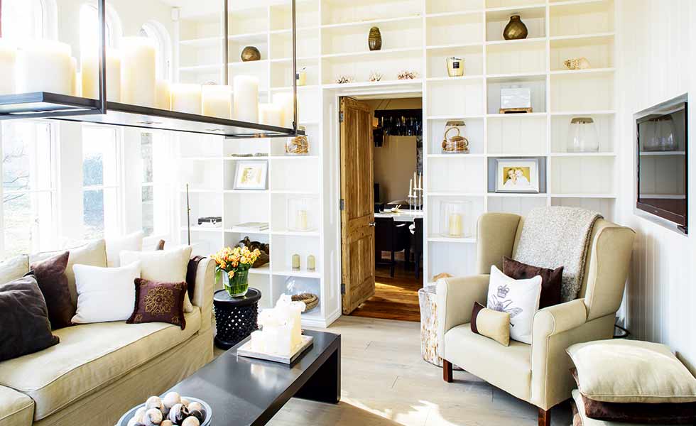 This living space features built-in shelving painted the same as the walls for effect
