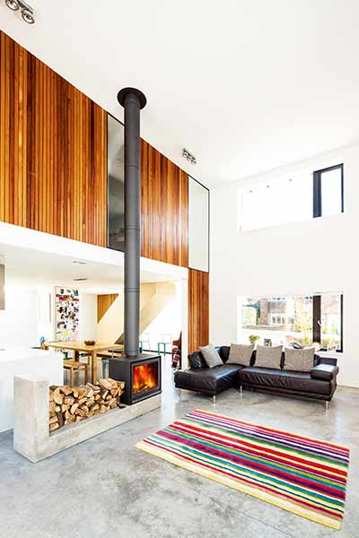 A woodburning stove in the centre of this project by architect Dan Brill creates a focal point in the living space