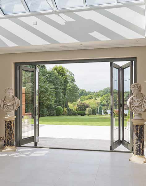 Bifold doors from Architectural Bronze Casements with a level threshold encourage indoor/outdoor living